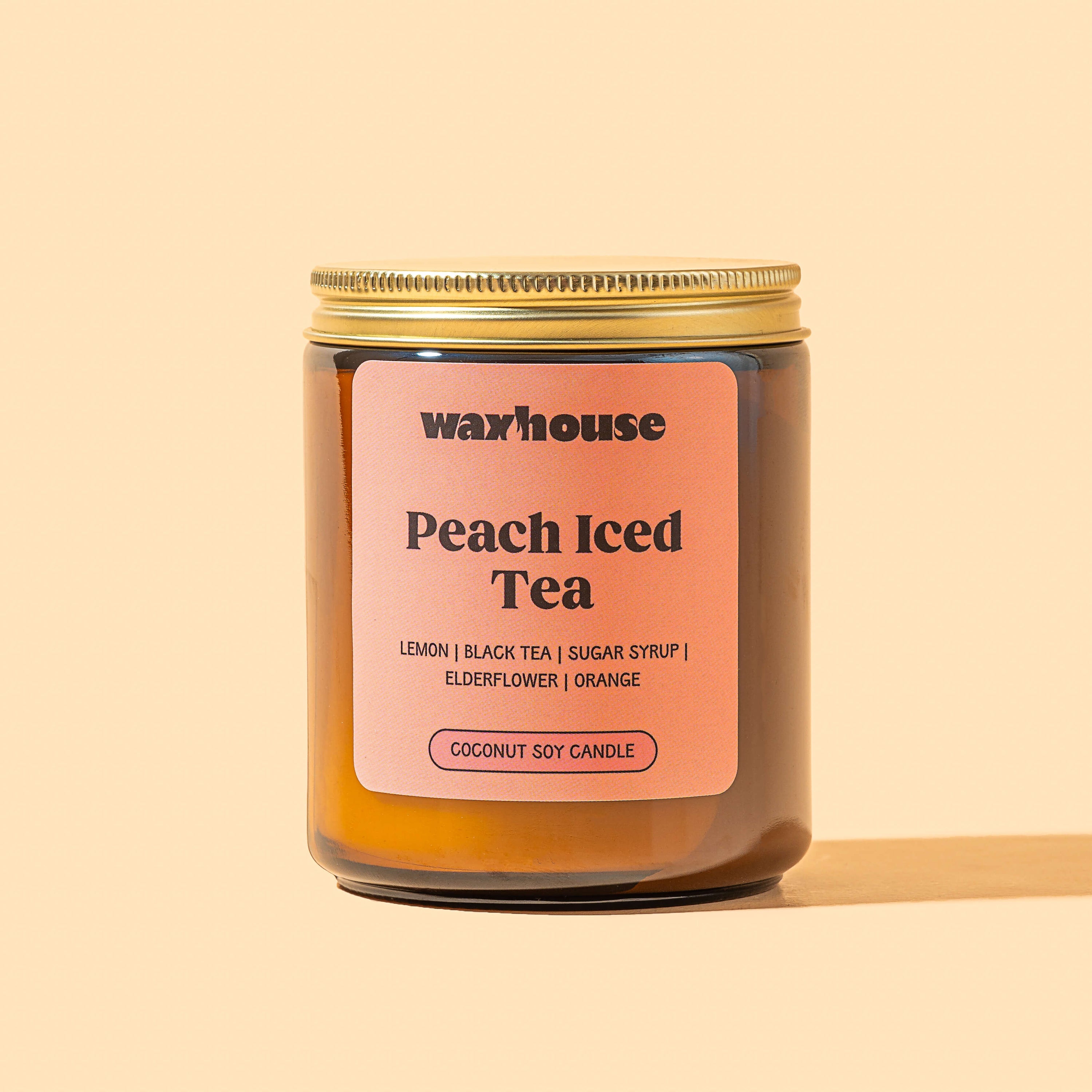 Waxhouse Peach Iced Tea candle on a beige background