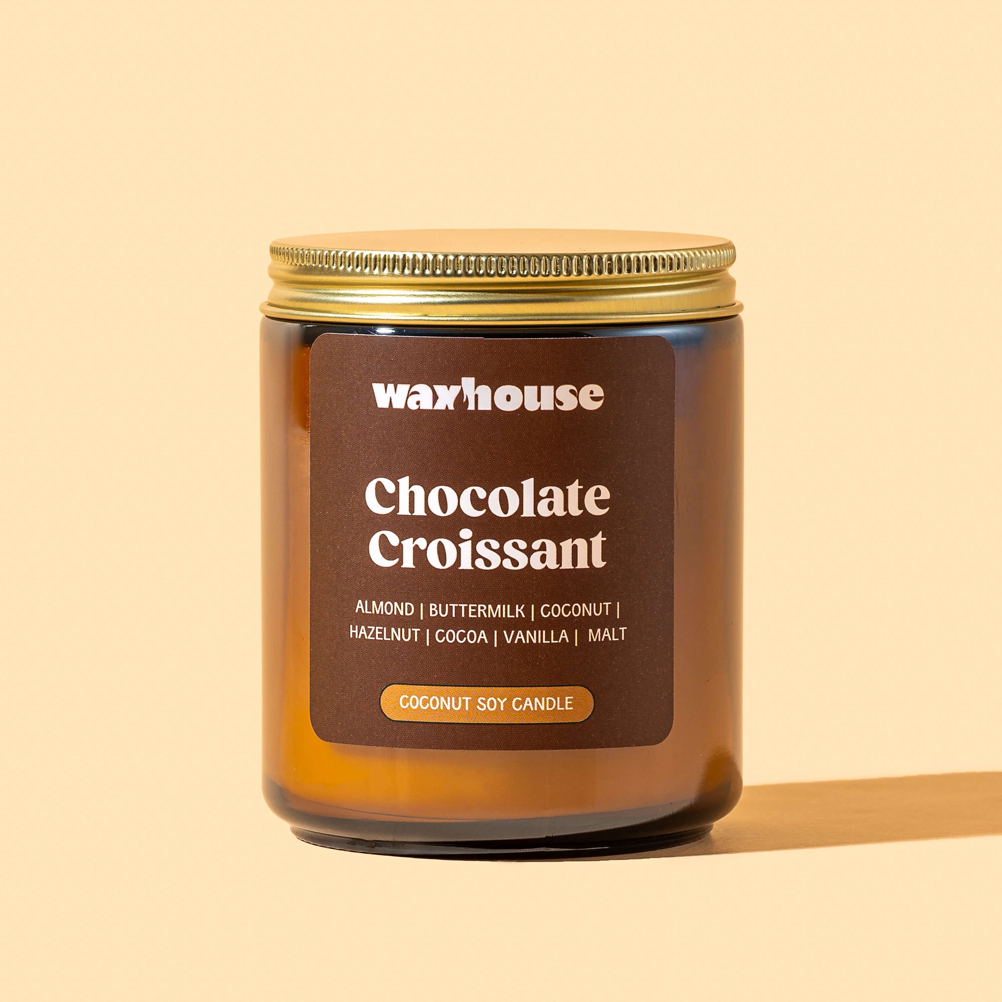 Waxhouse Chocolate Croissant candle on a beige background