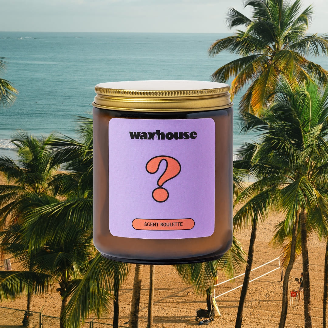 scent roulette candle sitting on beach background